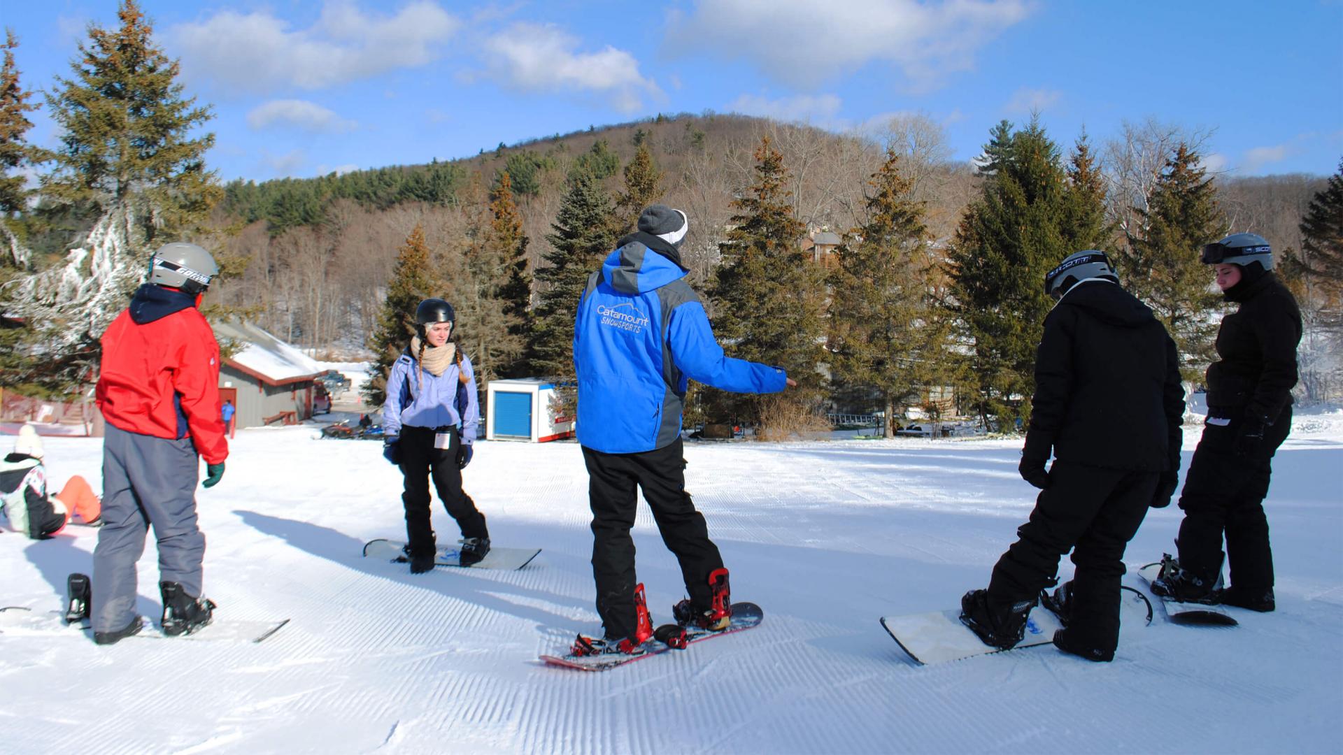 Snowboard instructor giving lessons at Catamount Resort